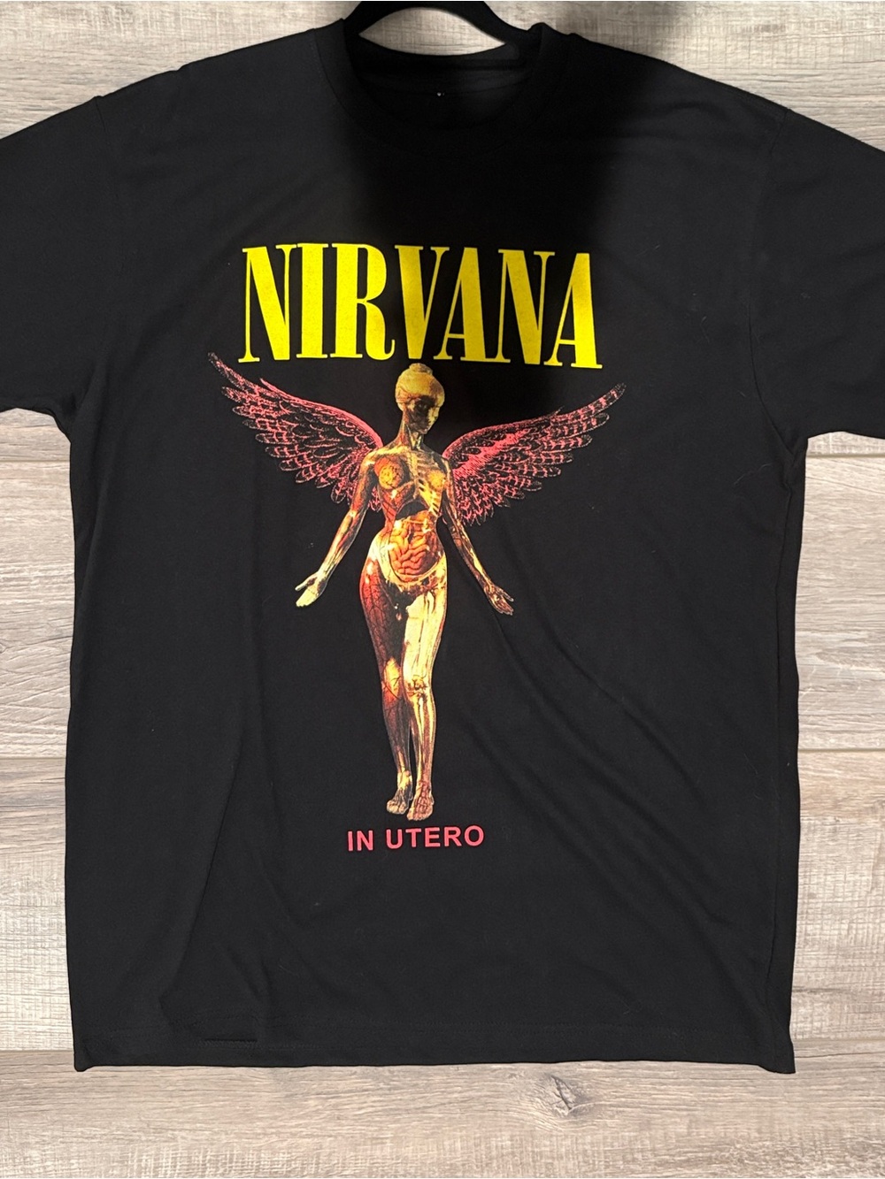 NIRVANA Black Tee with Yellow Logo and Red-Gold Angel Graphic